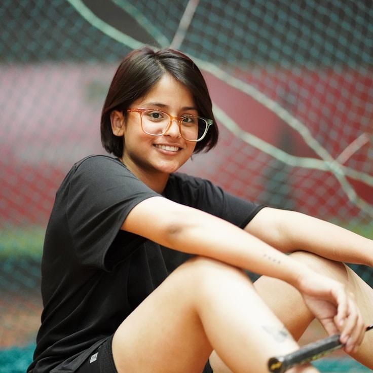 Asha Rao, Lead Design Curator at HarborPlumeField, reviewing corporate floral arrangements